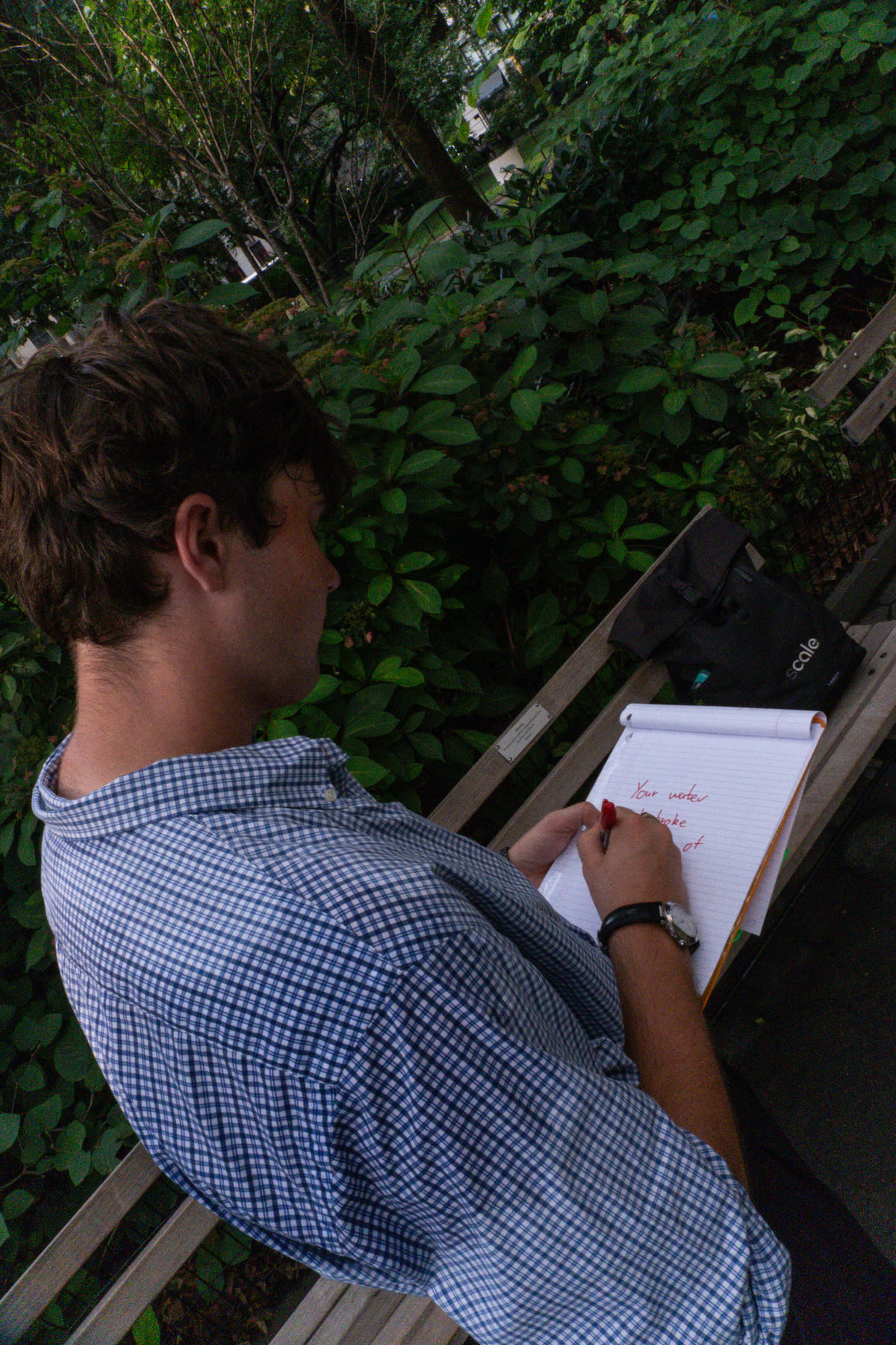 Fourth participant writing the next instruction on a clipboard
