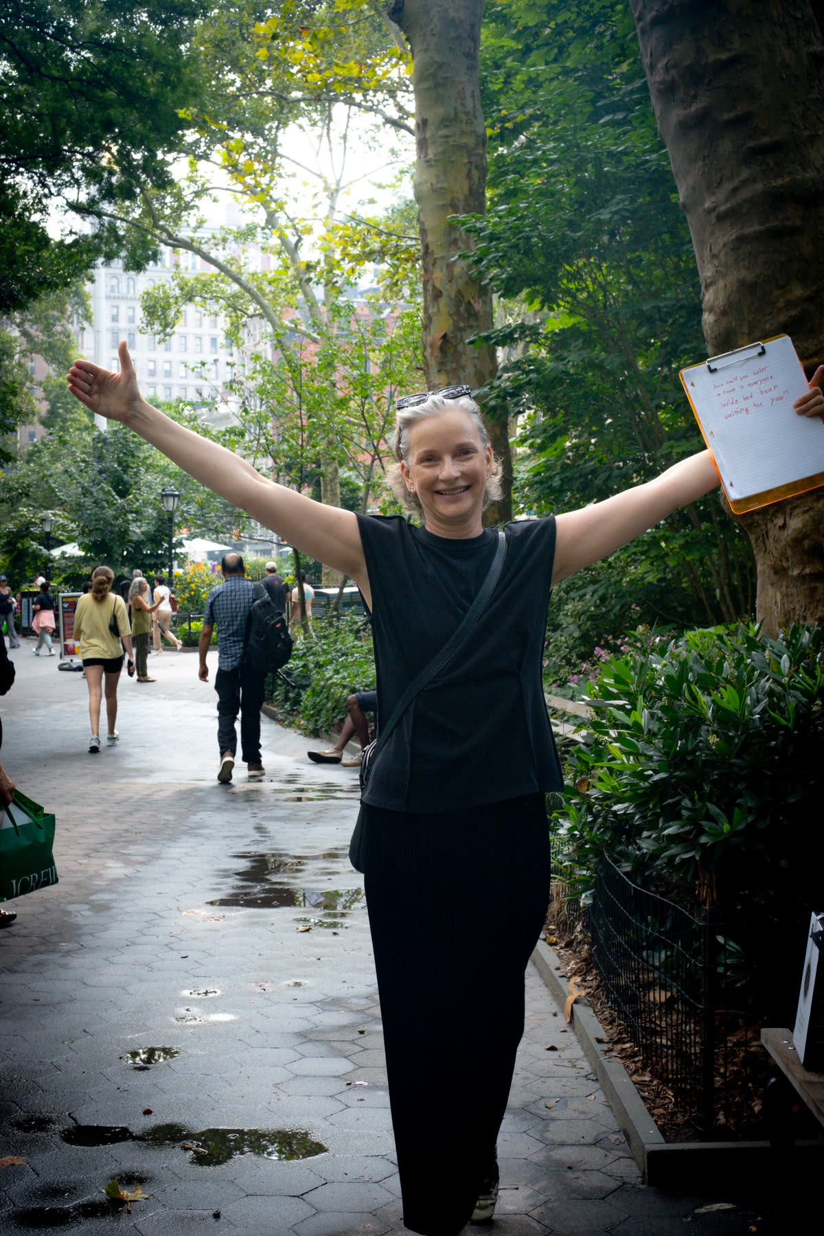 First participant standing in Madison Square Park with both arms spread wide
