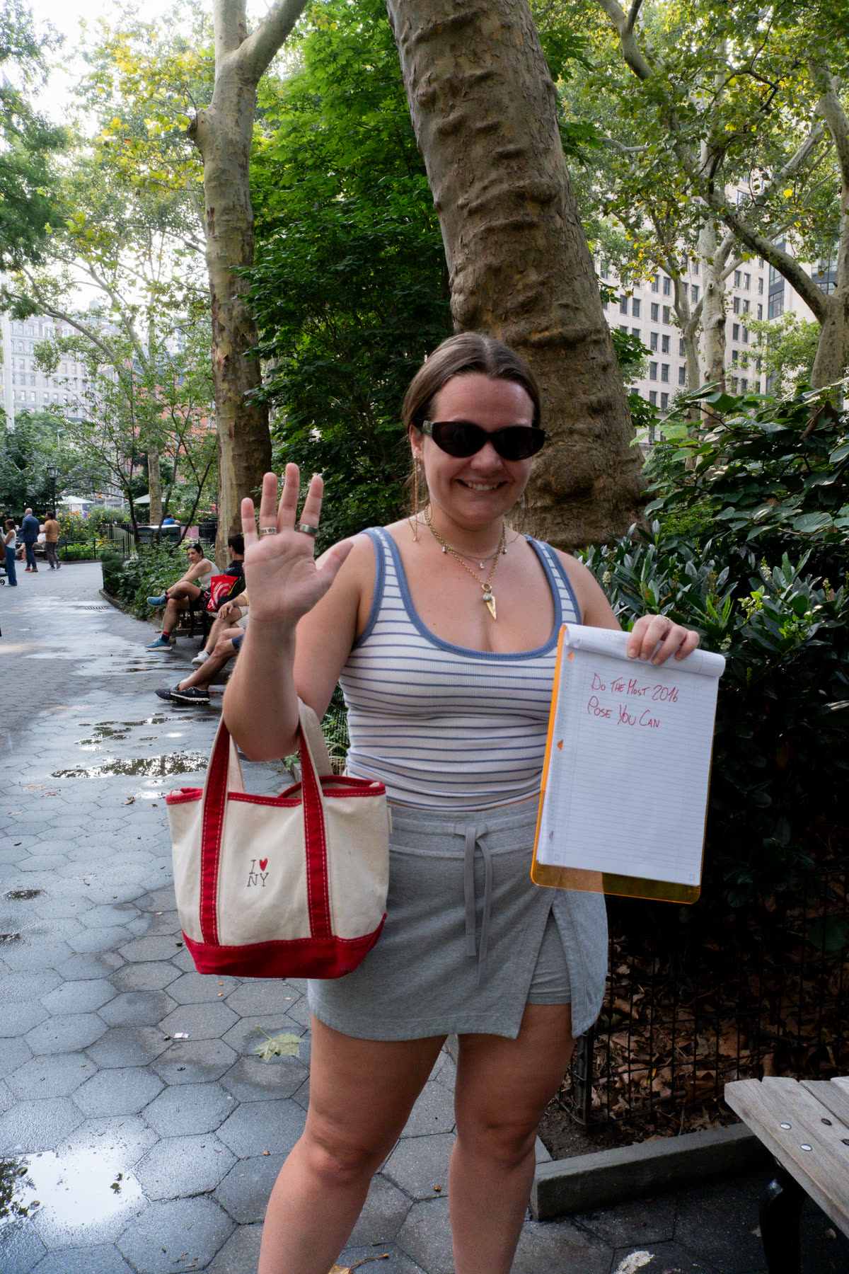 Third participant smiling, waving, and holding her instruction